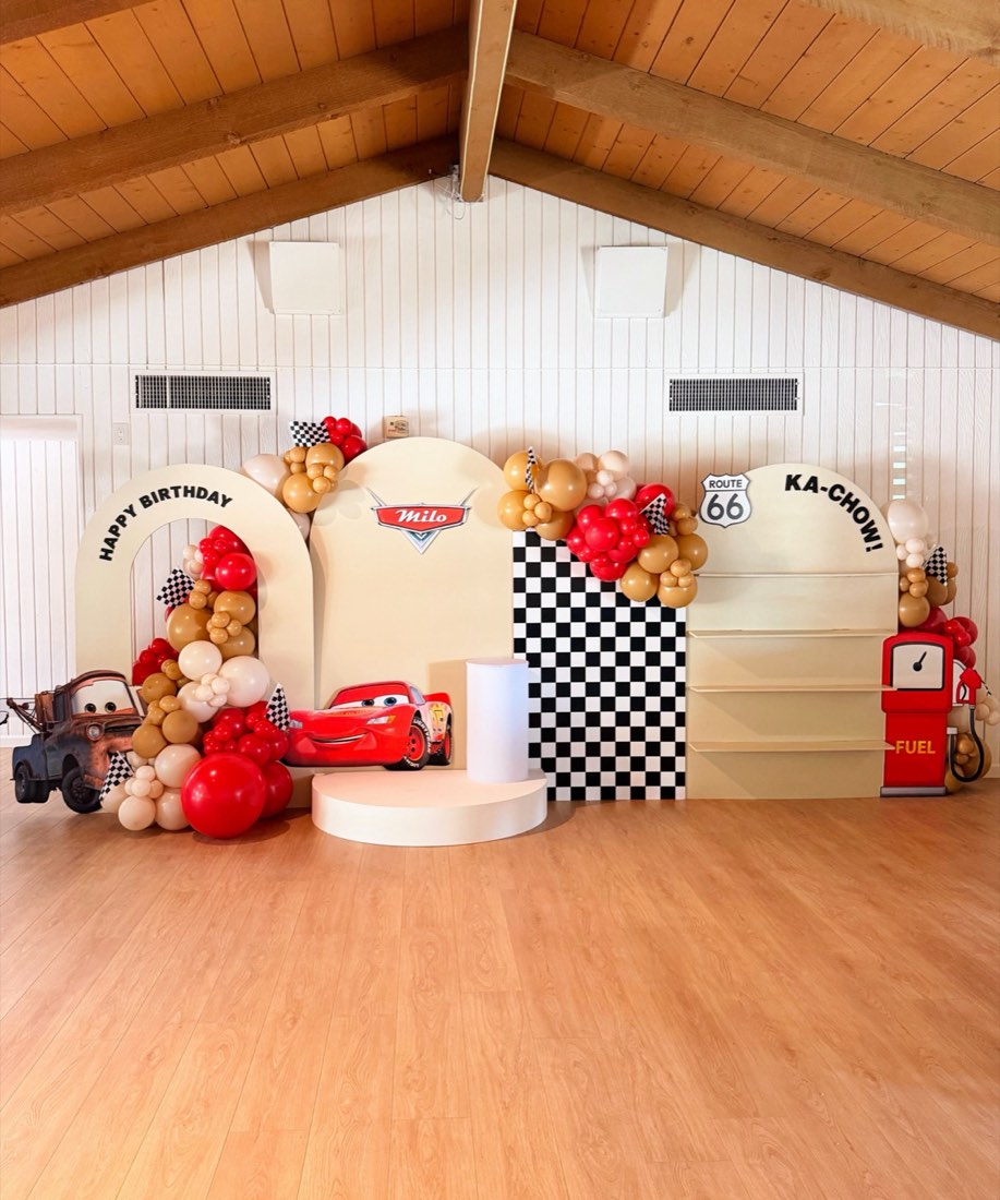 Cars Route 66 themed birthday balloon backdrop with checkered flag and Lightning McQueen by AZ Party Co.