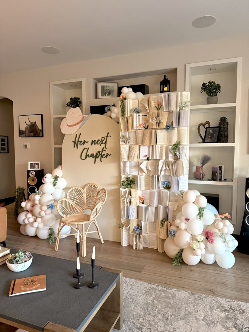 Her Next Chapter book-themed bridal shower balloon and floral backdrop by AZ Party Co.