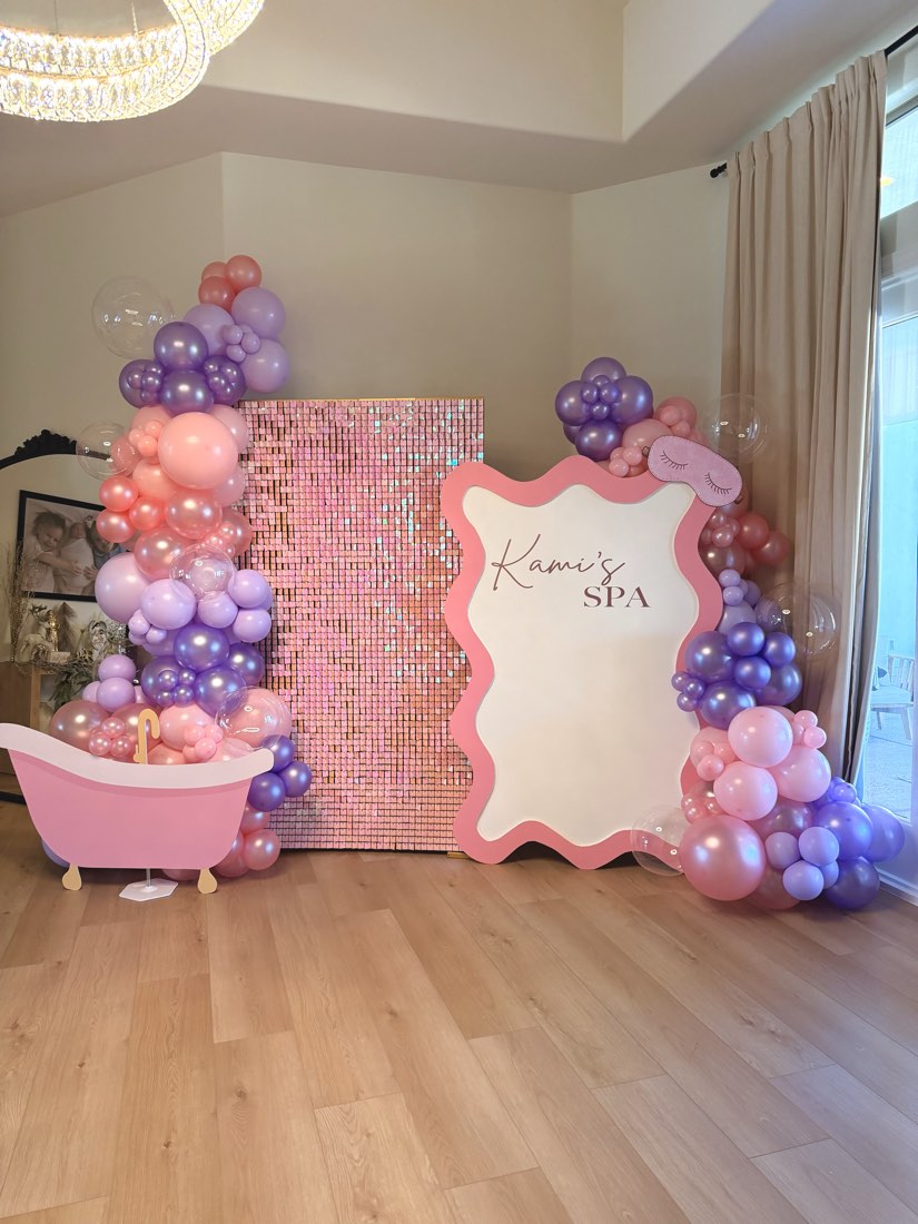 Kami's Spa pink and purple spa-themed birthday balloon backdrop with bathtub prop by AZ Party Co.